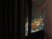 Naked standing hotel window