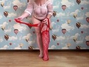 'Busty milf takes off nylons stockings from her plump legs puts on a sexy costume  Foot fetish'