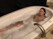 Young hottie getting massaged in a bathtub