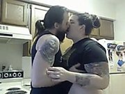 Tattooed brunette sucks a toy before poking it in her pussy