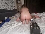 Wife enjoying fucking machine while licking hubby's ass
