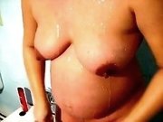 My pregnant busty wife in the shower room filmed on cam