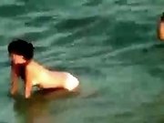 Hidden cam video with a slim brunette getting fucked on a beach