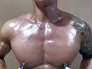 Worship this hot oiled up Asian muscle hunk as he show off his big pecs and play with his nipples