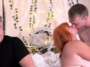 Busty redhead in hot lingerie is spoiled by two guys