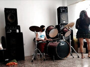 They play the drums for her - she dances, stripping and showing her ass