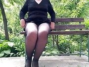 Naughty milf in pantyhose pissing in the park on a bench rear view