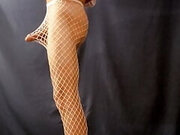 Sexy Sandy poses and strokes her clit in white mesh pantyhose