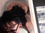 Tattoo milf with glasses fucks in the bathtub