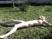 My blonde slut lying tied up on the lawn